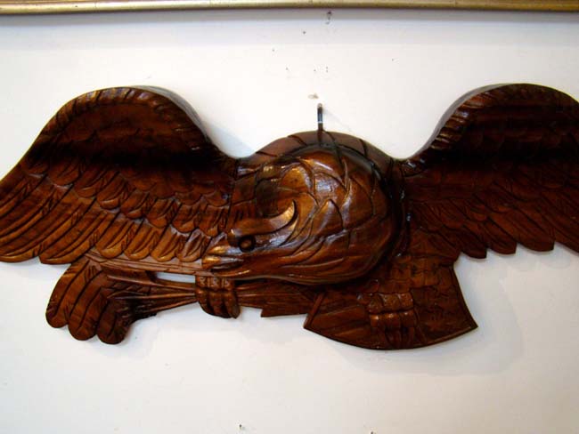 A contemporary carved walnut American spread wing eagle
